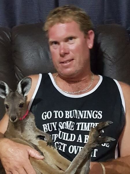 Rob Hewton holding a kangaroo